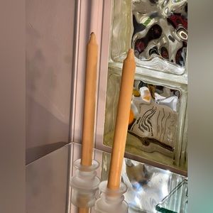 One set of cream colored candles and frosted glass holders.